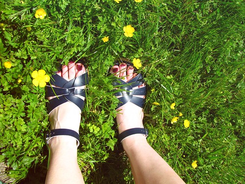 navy saltwater sandals and yellow flowers