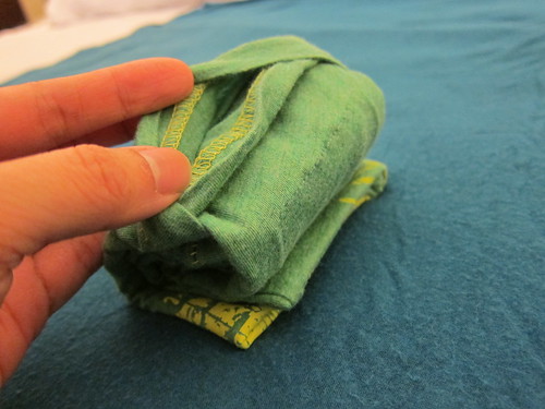 8. Get the top flap and pull it backward and over the little bundle.