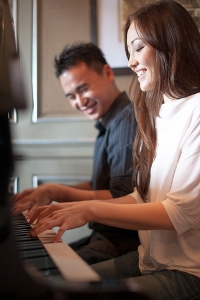 Image of couple playing piano