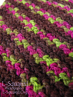 Close-up of the skinny diagonal lines of the cuffs which alternate from pink and green to brown. 
