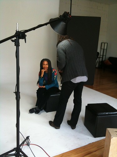 Sharan, sitting serenely, as she's being photographed by Lamont