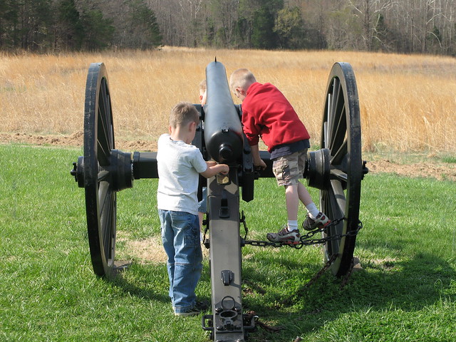 Children play on a canon located on the battlefield at the Overton-Hillsman House.