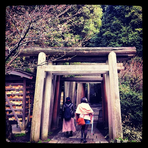 Two girls walking into an endless #tunnel of a #japanese #shrine