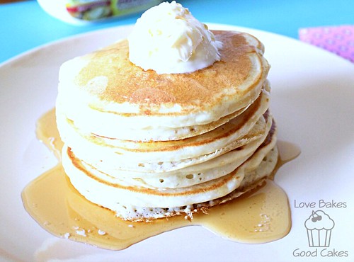 Buttermilk Pancakes stacked on plate with butter and syrup.