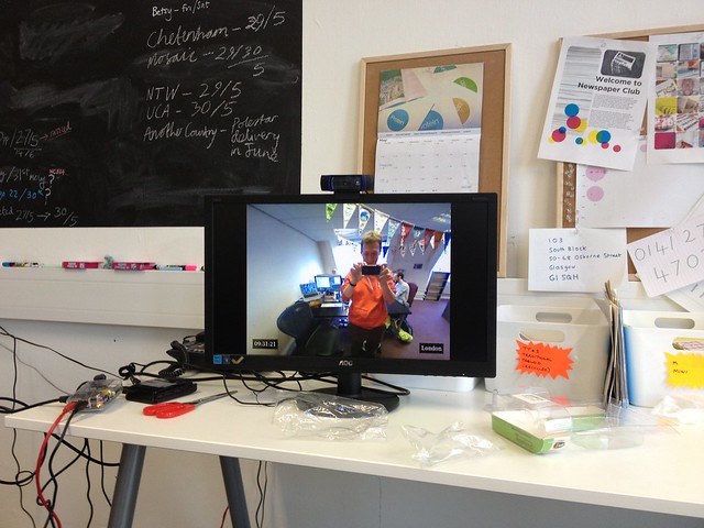 There's a Raspberry Pi at each end, each connected to a webcam and a monitor. You should be able to put a pair together for under <£150, if you can find a spare monitor or two. There's no sound, and the video is designed to look reasonable, while being tolerant of a typical office's bandwidth constraints.