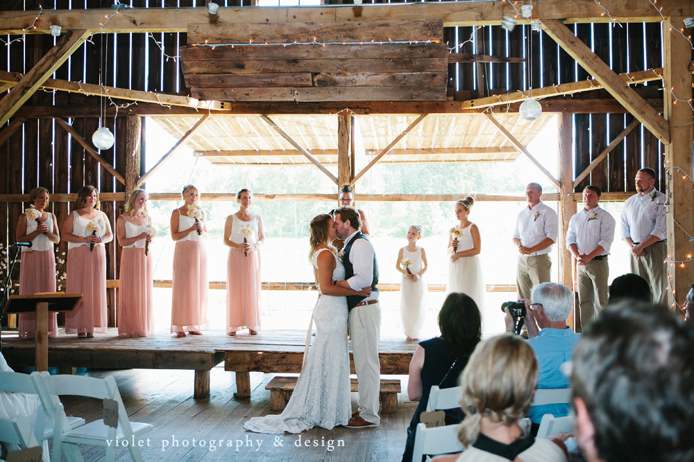 bride & groom kiss in the barn