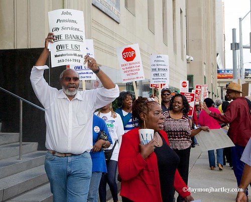 Abayomi Azikiwe, editor of the Pan-African News Wire, marching with City of Detroit workers, retirees and community activists outside federal court during the second day of bankruptcy hearings. Moratorium NOW! is calling for debt cancellation. by Pan-African News Wire File Photos