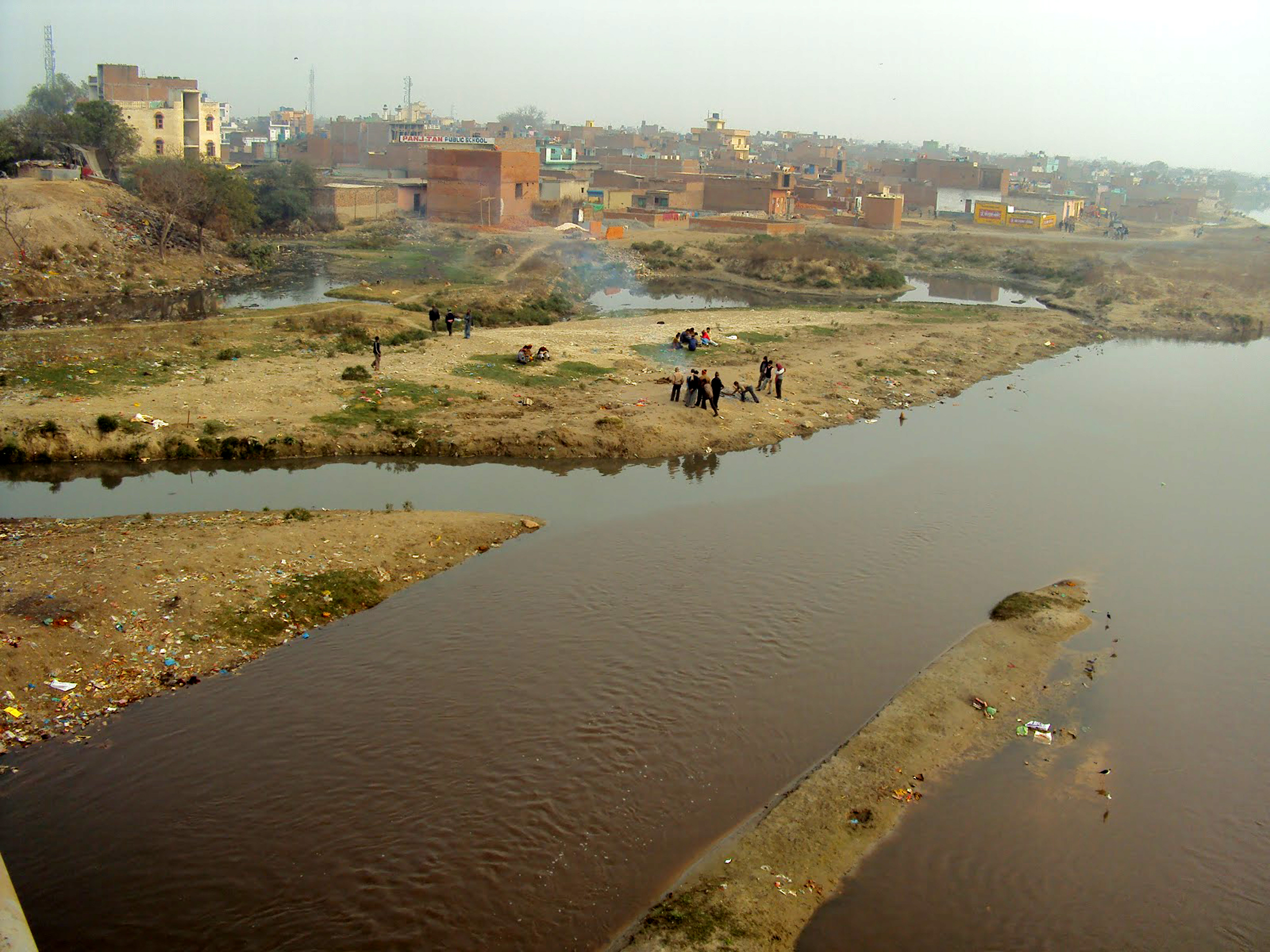 हिंडन नदी के किनारे अवैध रूप से बसाई गई कालोनी का दृश्य
