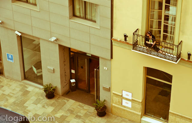 Woman on balcony in Malaga, Spain