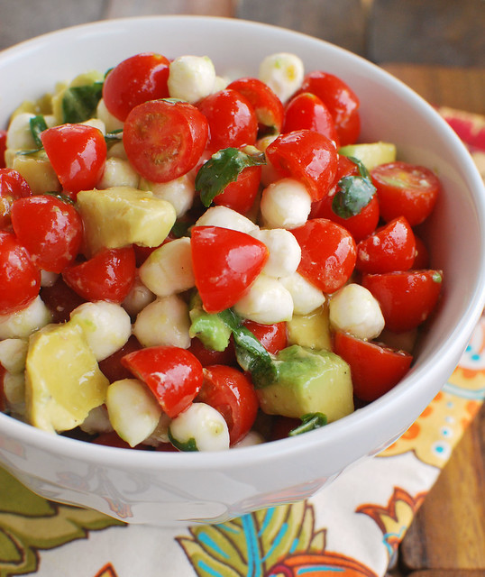 Mozzarella, Tomato, Avocado Salad - cherry tomatoes, fresh mozzarella, avocado, and fresh herbs tossed in a light lemony dressing. Perfect summer side dish or pile it on grilled chicken! 