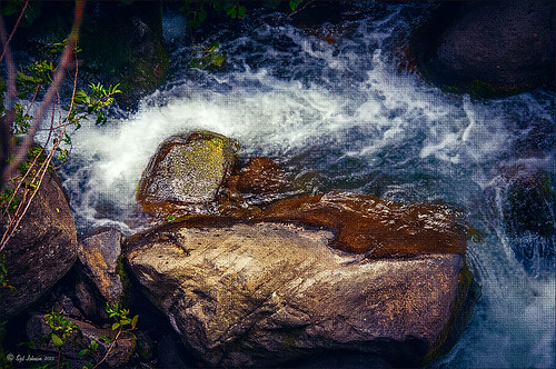 Image of water flowing past a rock at Iao Valley in Maui