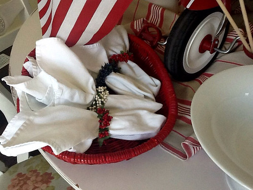 Red white and blue berry napkin rings over white napkins
