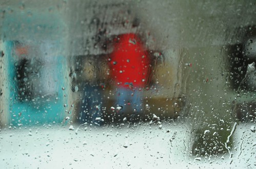 Abstact: People window shopping in the rain after snow fall, Greenwood, Seattle, Washington, USA by Wonderlane
