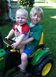 Giving his brother a ride on his tractor.