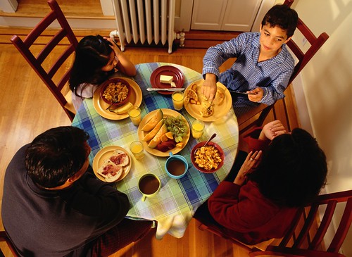 Family of four has dinner together. New USDA report examines the anti-poverty effects of the Supplemental Nutrition Assistance Program (SNAP). Photo: Thinkstock