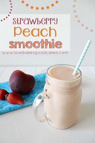 Strawberry Peach Smoothie in glass with straw and fresh fruit.