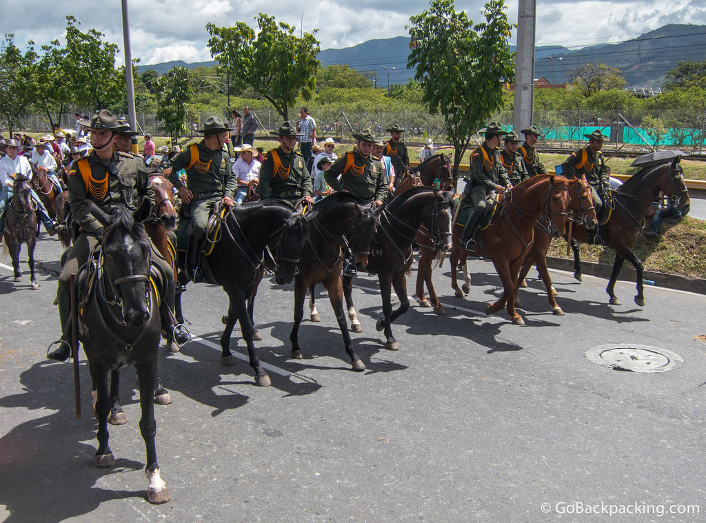A row of mounted police form a control line to help keep some semblance of safety and order amongst the thousands of riders, horses, and spectators