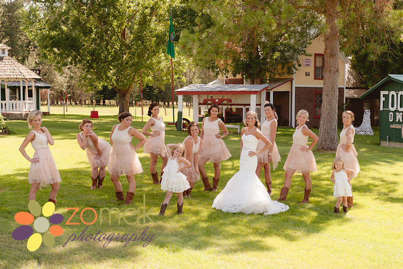 A large wedding party take a sassy pose at the reception location before the wedding ceremony.