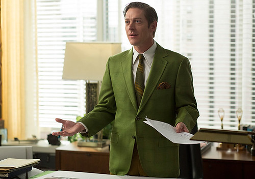 Ted Chaough in a green blazer standing behind a desk