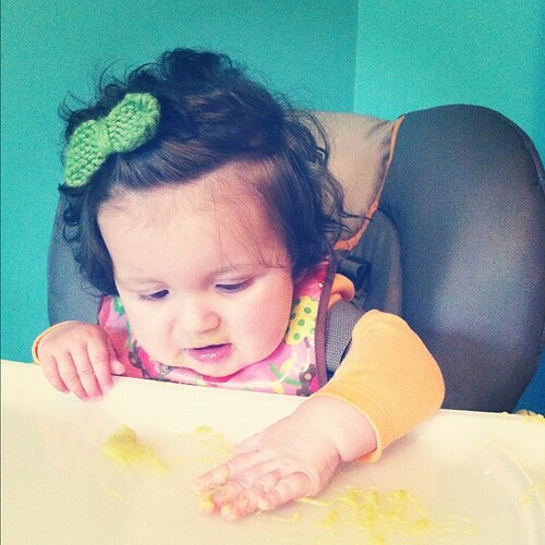 Gettin messy with peas. By the way - she loves to eat solids now! 
