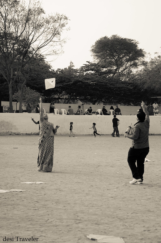 a women in saree flying kite
