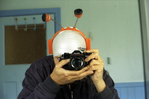 reflected self-portrait with Fuji STX-2 camera and Halloween headgear by pho-Tony