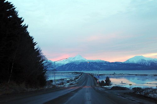 Entering onto the Homer Spit, open road, winter, Katchemak Bay, snowy mountains, pink twilight, Homer, Alaska, USA by Wonderlane