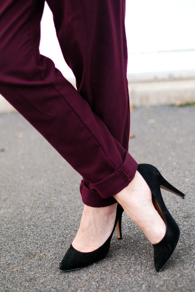 Purple peg legs and black pointed heels