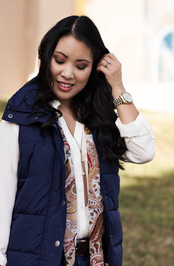 cute & little blog | navy quilted puffer vest, white blouse, tassel necklace, paisley scarf, skinny jeans | fall trend layering outfit