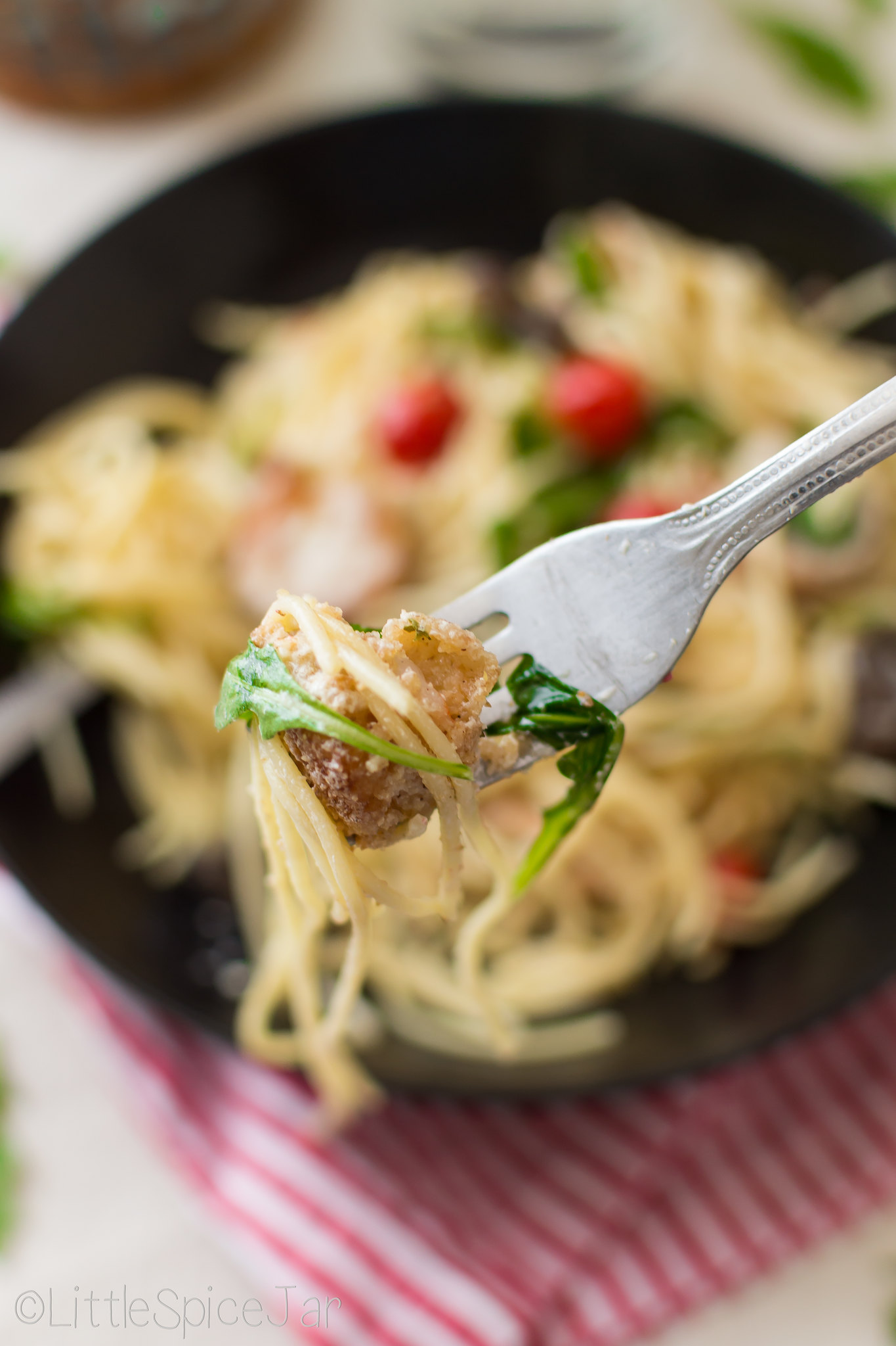 shrimp pasta and arugula on fork