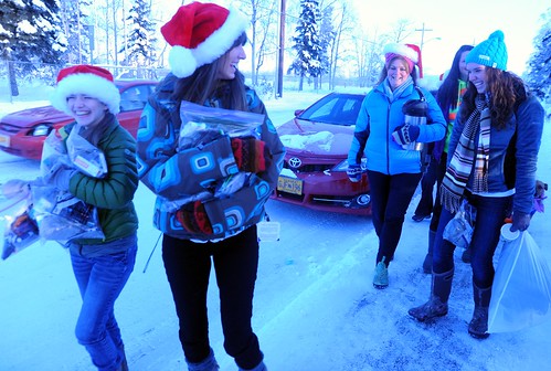 Pretty playful Santas, community volunteers out to spred Christmas joy to the world - distributing hot cider, cookies, candy, and other goodies, on a cold day with snow, Rosie is behind them all the way, Anchorage, Alaska, USA by Wonderlane