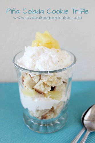 Piña Colada Cookie Trifle in glass with whipped cream and pineapple chunks.