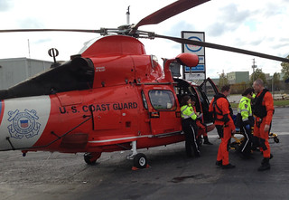 A Coast Guard aircrew, from Air Station Detroit, involved with a medevac of a 57-year-old man transfers the patient to paramedics at the Windsor, Ontario Airport. October 27, 2013. The aircrew assisted Joint Rescue Coordination Centre Trenton, Ontario, with the medevac off of the 730-foot Algoma Enterprise, which was passing through the Pelee Passage in Lake Erie. U.S. Coast Guard photo by Lt. Jim Cepa.