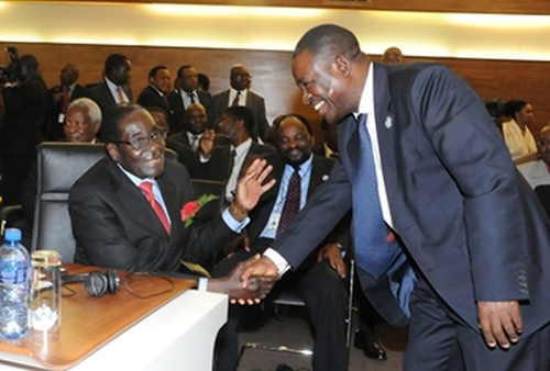 Zambian Minister of Justice Wynter Kabimba greets Republic of Zimbabwe President Robert Mugabe at the SADC summit on developments in the Great Lakes. by Pan-African News Wire File Photos