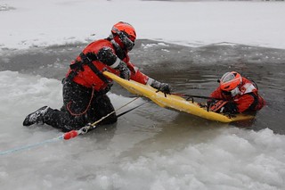 Members of Coast Guard response crews from throughout the Great Lakes region, including Air Stations Detroit and Traverse City, participate in Ice Rescue Training and a Ready For Operations Course held at Coast Guard Station Portage, Mich., which included the use of a MARSARS board, Dec. 11, 2013. Snow and subzero temperatures provided ideal conditions for the three-day training session. (Coast Guard photo by Chief Petty Officer Casey McDonald)