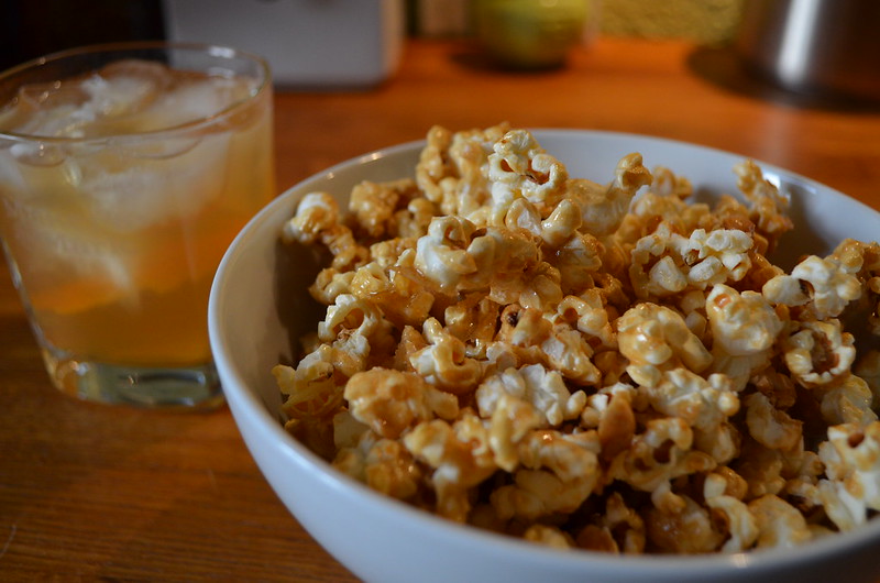 Salted caramel bourbn popcorn with peanuts served with bourbon