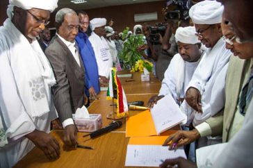 Representatives of Sudan (left) and leaders of Abbala and Beni Hussein ethnic groups (right) sign the document of agreement in the North Darfur Wali (Governor) residence in El Fasher, North Darfur. by Pan-African News Wire File Photos