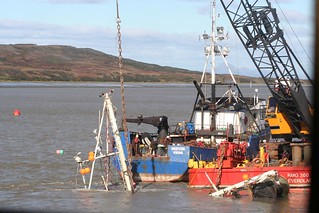 Resolve-Magone Marine Services salvage crews attach chains to the fishing vessel Lone Star during an attempt to recover the vessel from the Igushik River near Dillingham, Alaska, Sept. 21, 2013. The vessel was successfully moved 200 feet toward the east shore Sept. 30. U.S. Coast Guard photo by Lt. Daniel Peters.