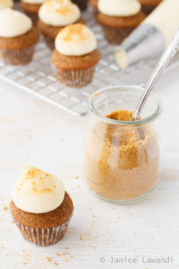 apple spice cupcakes topped with cream cheese frosting and graham cracker crumbs