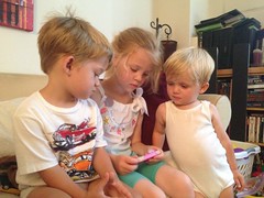 Olivia's phone reads "Rapunzel" to the boys by Guzilla