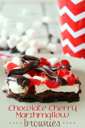 Chocolate Cherry Marshmallow Brownies up close on a white plate with mini marshmallows in background.