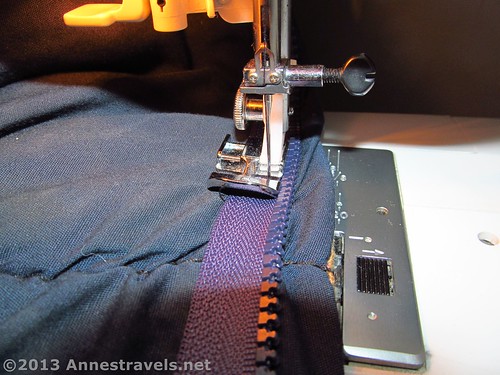 Sewing a new zipper into a sleeping bag to replace a broken zipper.