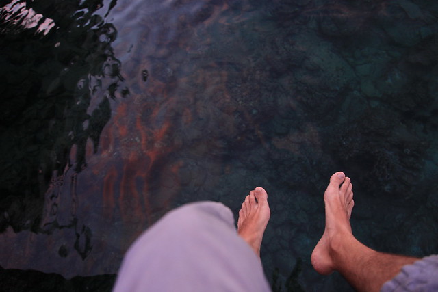 Feet in sunset reflection on water, Iboih, Sabang, Pulau Weh