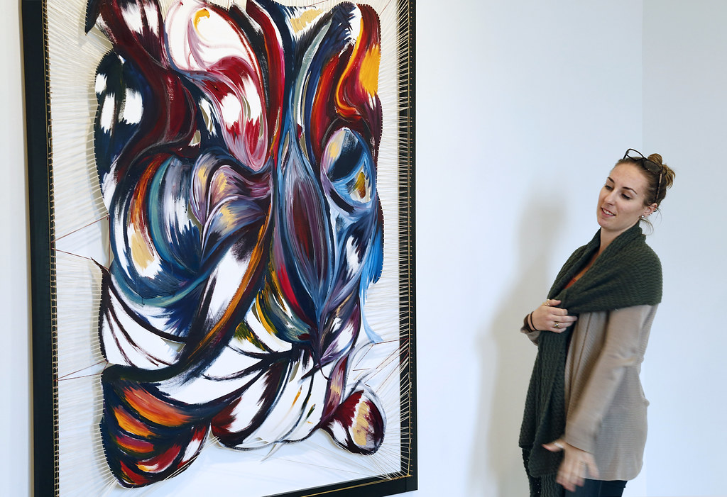 Kate Huffman (M.F.A. '18) with her painting in the Experimental Gallery.