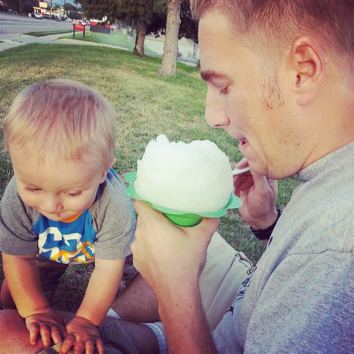 Baby likes shaved ice.  Baby and dad have same goofy face