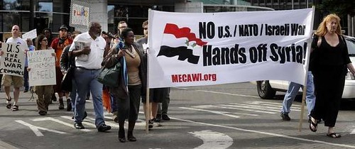 Demonstrators march through downtown Detroit opposing the U.S. war drive against Syria. Hundreds took to the streets demanding no war on Syria. by Pan-African News Wire File Photos