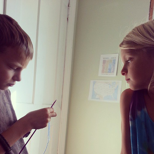 Precious. Little sis is teaching her brothers to knit.