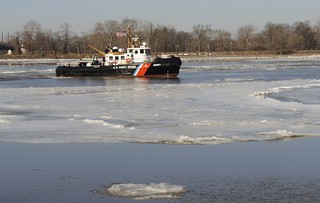 The Coast Guard Cutter Capstan, a 65-foot ice-breaking tugboat homeported in Philadelphia, breaks ice on the Delaware River, near the Burlington-Bristol Bridge, Thursday, Jan. 9, 2014. The Capstan crew worked to help prevent flooding and maintain navigable waterways. U.S. Coast Guard photo by Petty Officer 3rd Class Cynthia Oldham