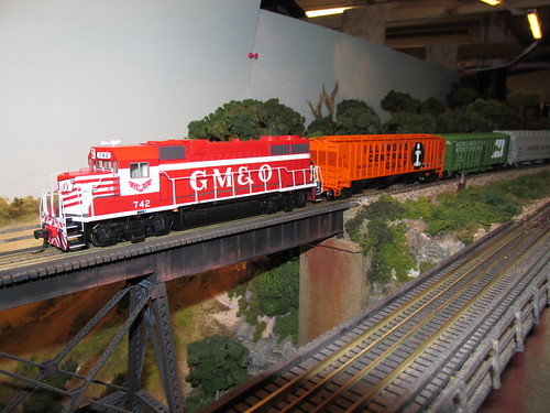 A 1970's era Illinois Central Gulf train with a former G,M & O locomotive up front enters the tall steel trestle.  The Oak Park Society of Model Engineers,H.O Scale Model Railroad Club.  Oak Park Illinois.  October 2013, by Eddie from Chicago