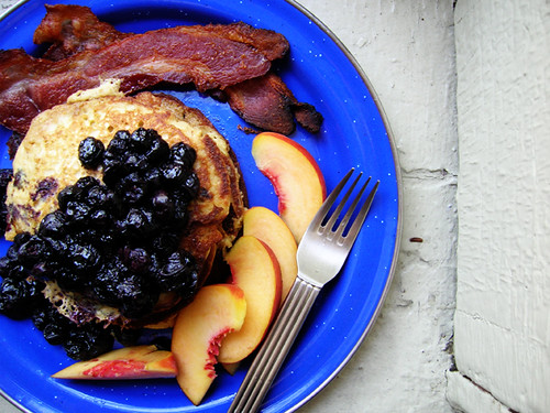 oatmeal lemon ricotta pancakes with blueberry compote, peaches, and bacon